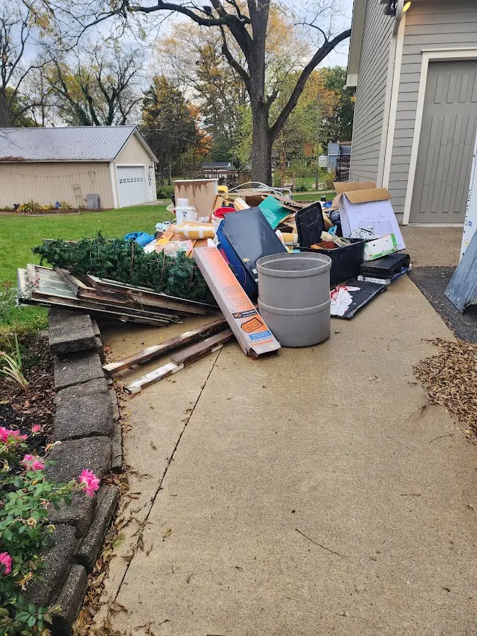 Dumpster being loaded with debris for Residential Dumpster Rental in Toledo